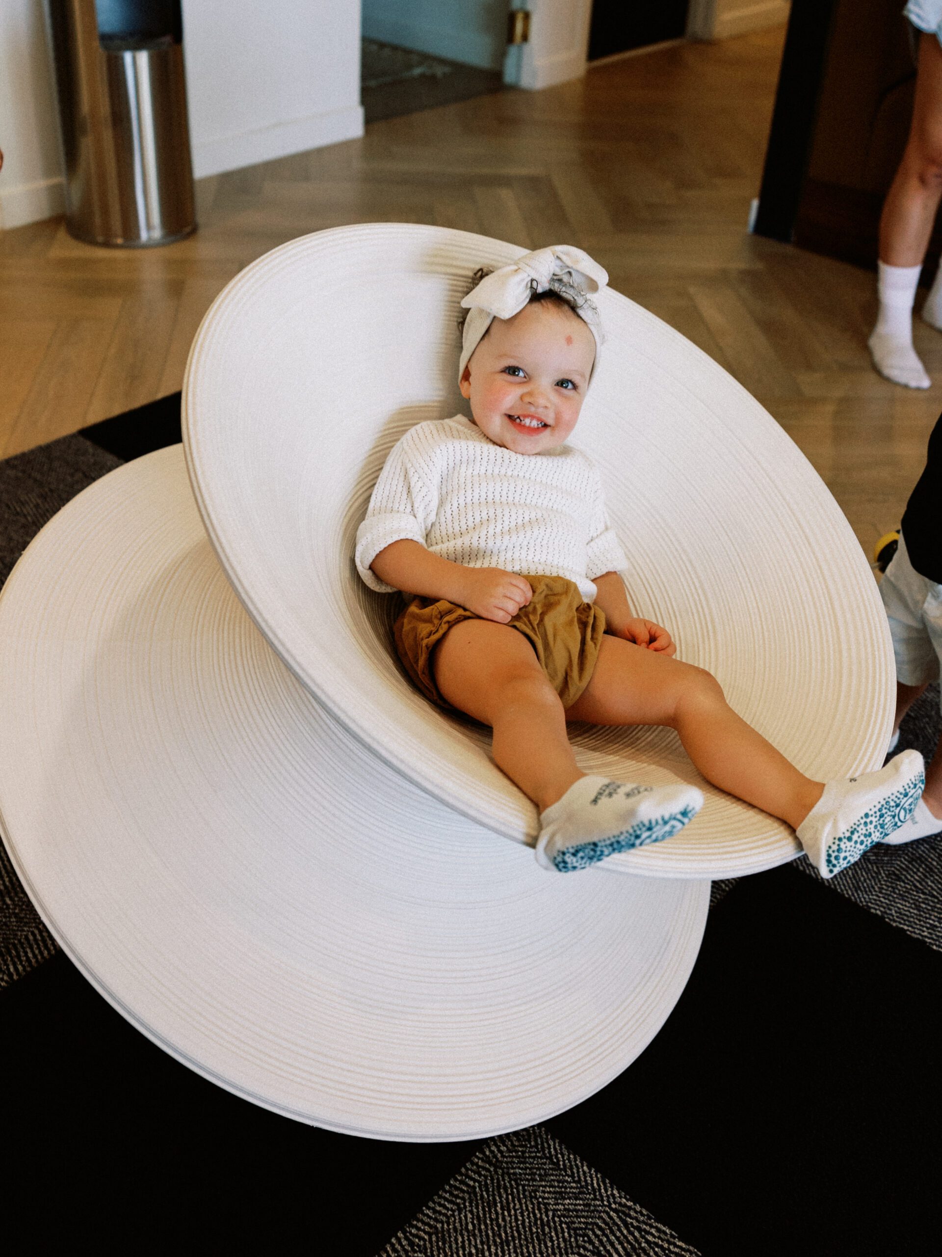 Happy toddler enjoying luxury play area at The Little Play Avenue children's club in Phoenix, AZ