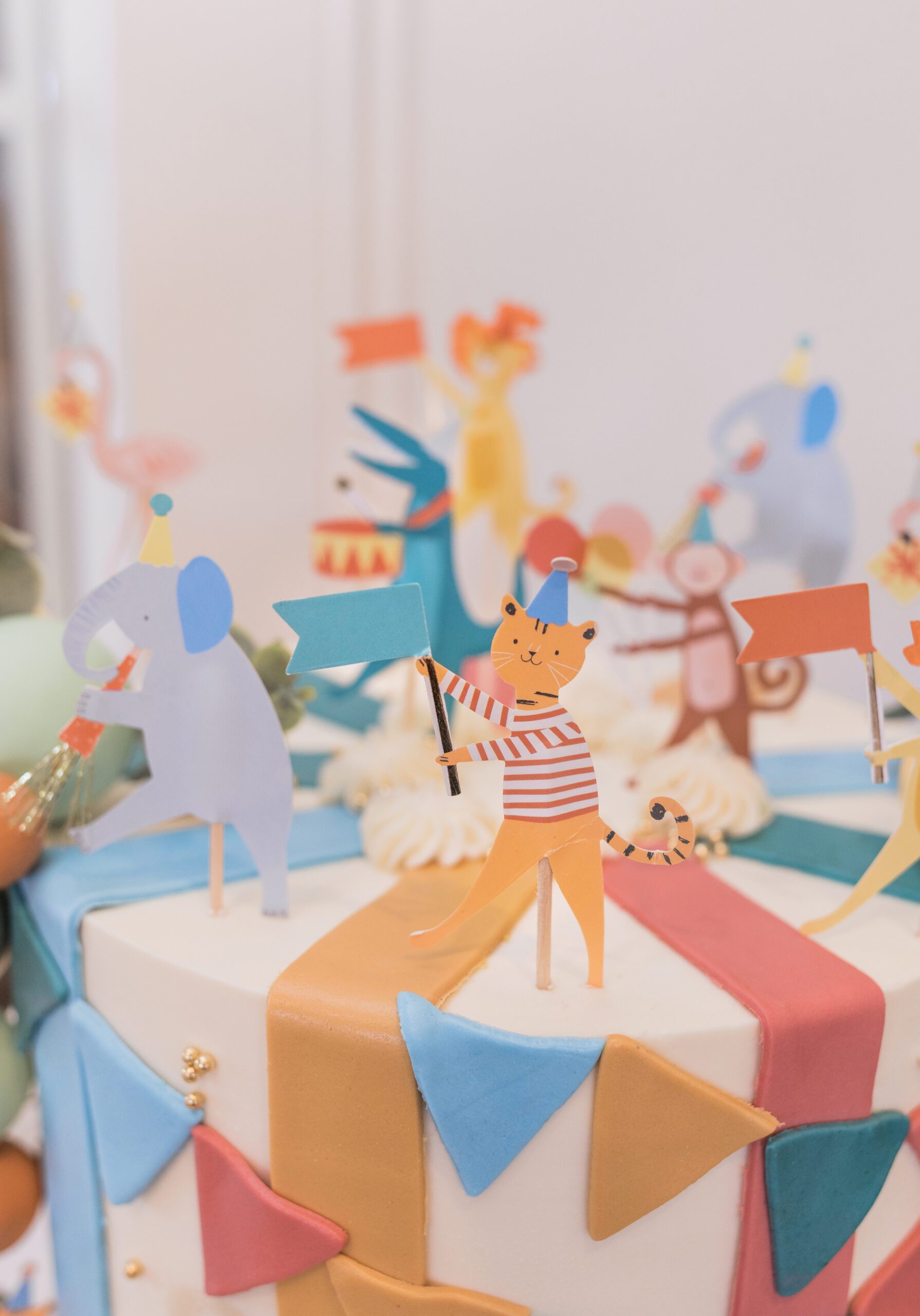 Luxury circus-themed children's birthday cake decor with playful animal toppers at The Little Play Avenue in Phoenix, AZ
