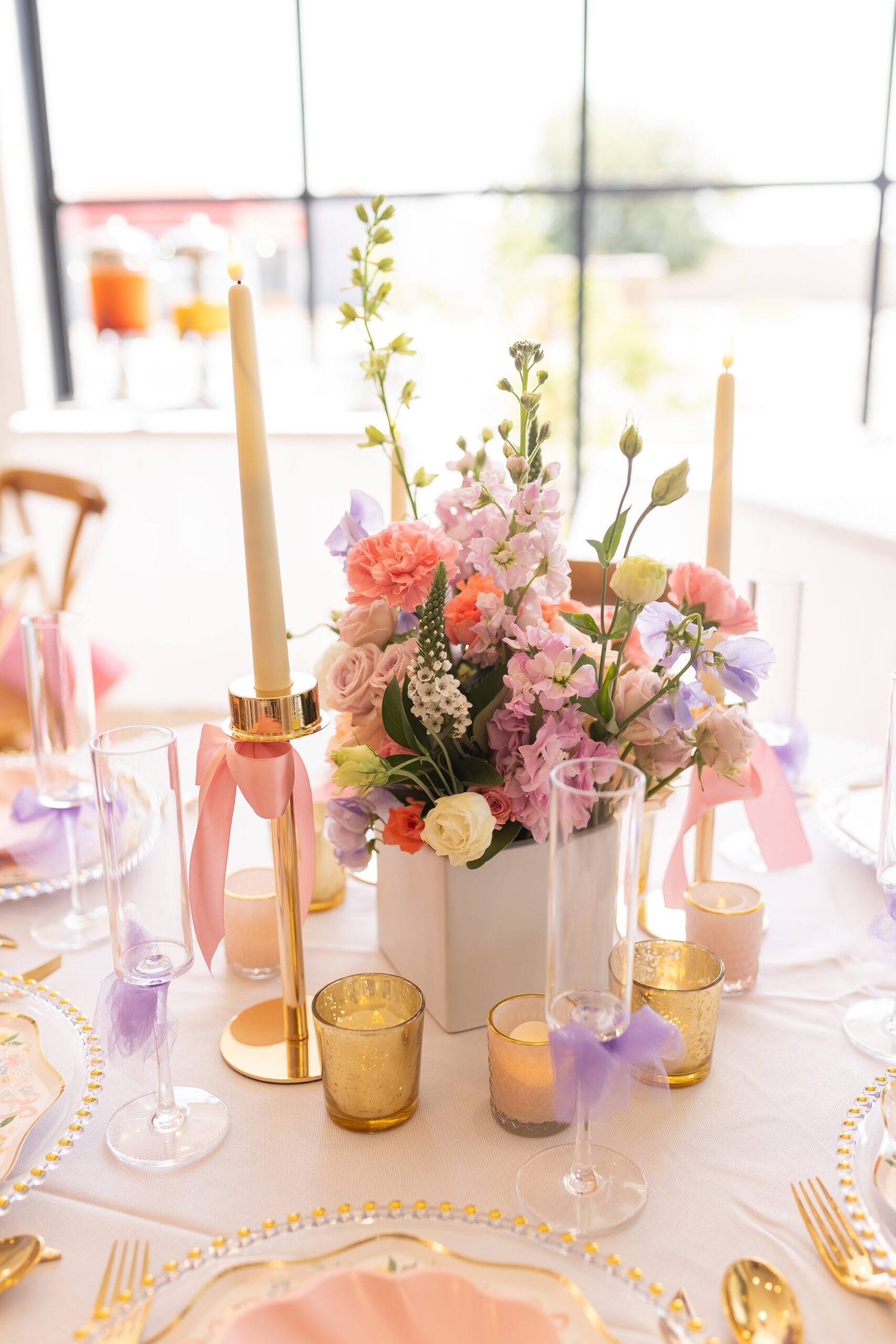 Floral centerpiece with candles and gold accents
